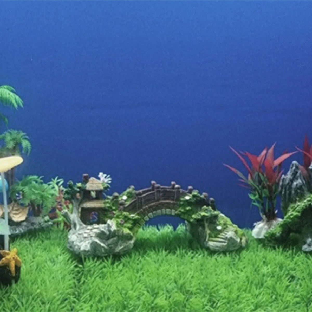 Fish swimming around a resin aquarium hideaway