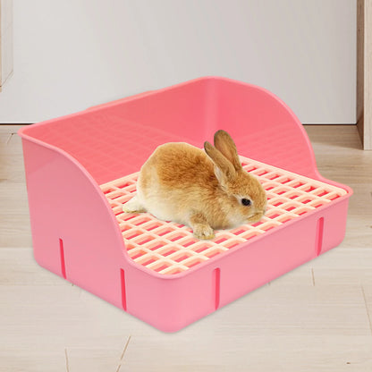 Rabbit sitting in the pink raised-grid litter box