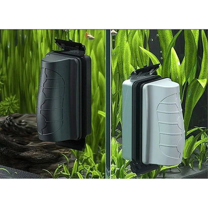 Black and white magnetic aquarium glass cleaners inside a planted tank